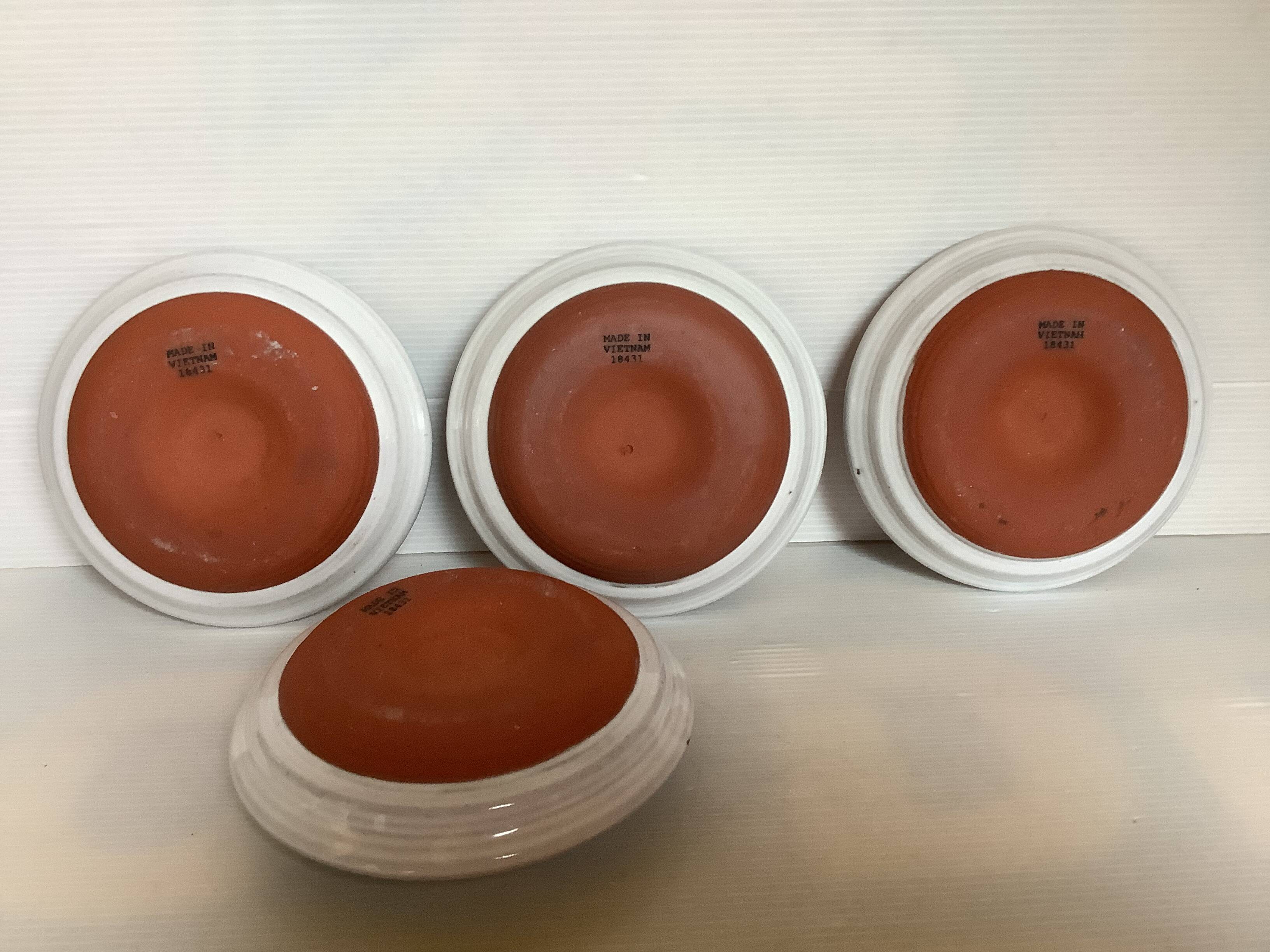 Four ceramic candle holders