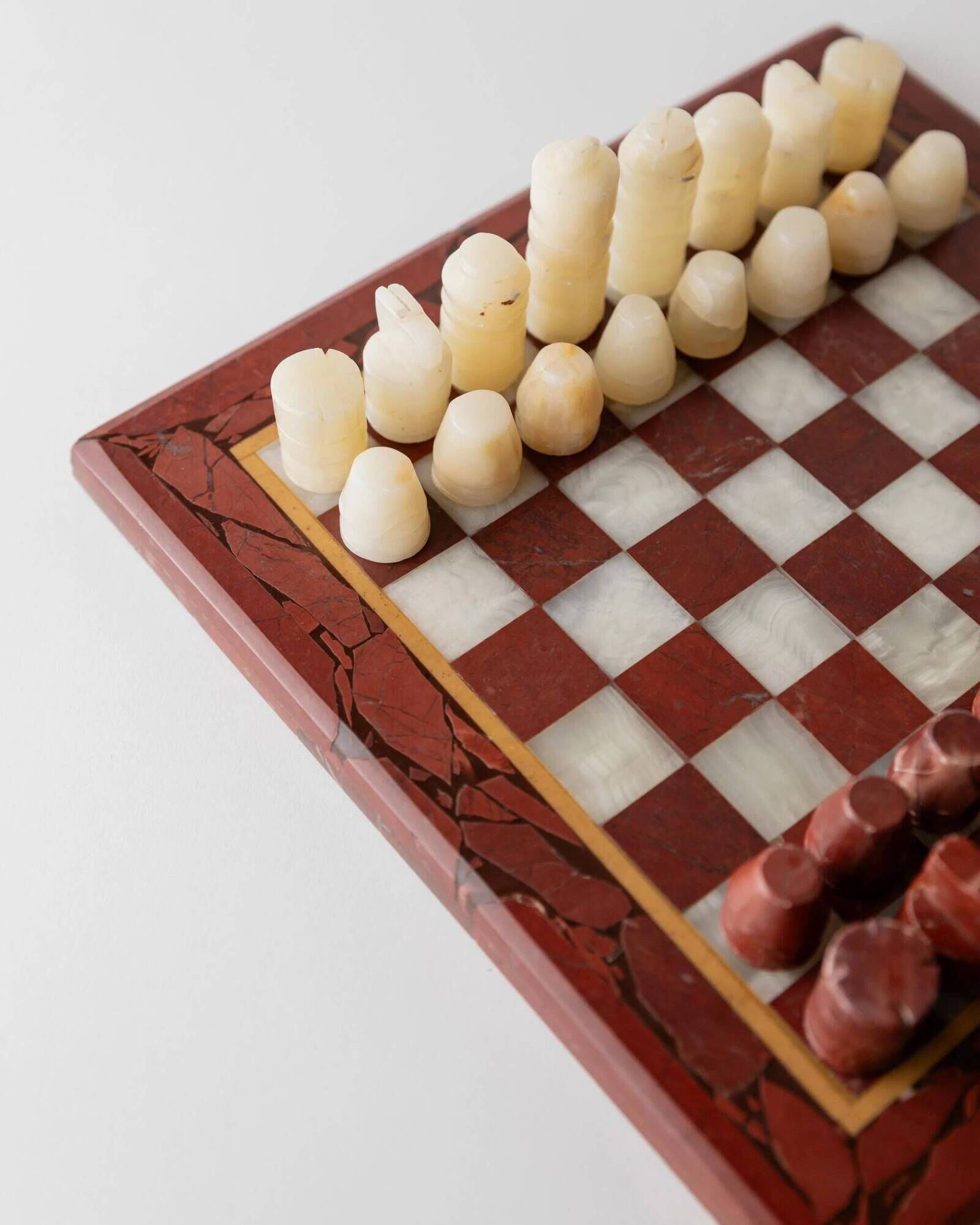 Vintage marble chess set from the 1960s, cream, burgundy and gold board with metal inlay, stone pieces.