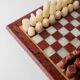 Vintage marble chess set from the 1960s, cream, burgundy and gold board with metal inlay, stone pieces.