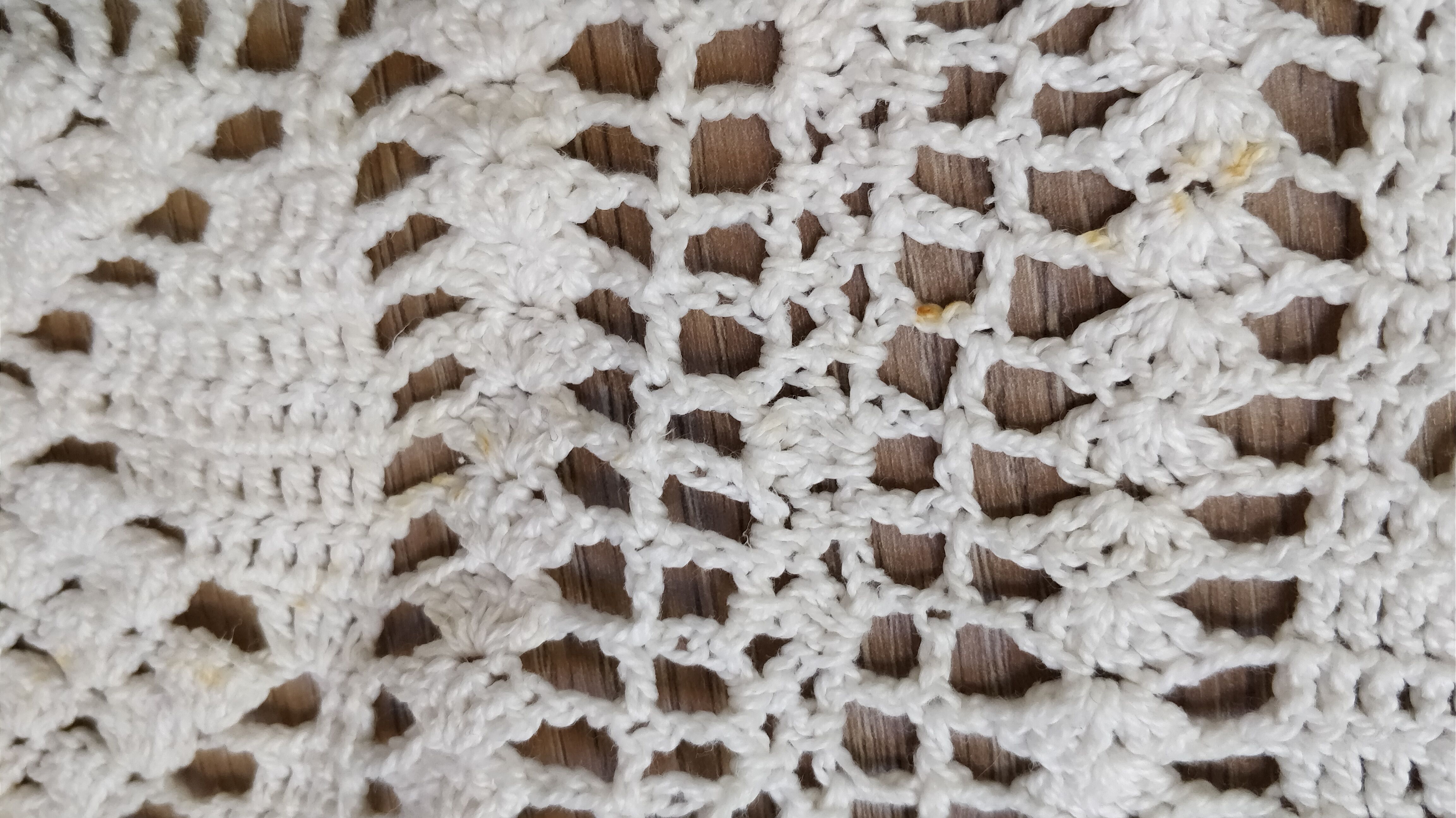 White two-seater crocheted bed top