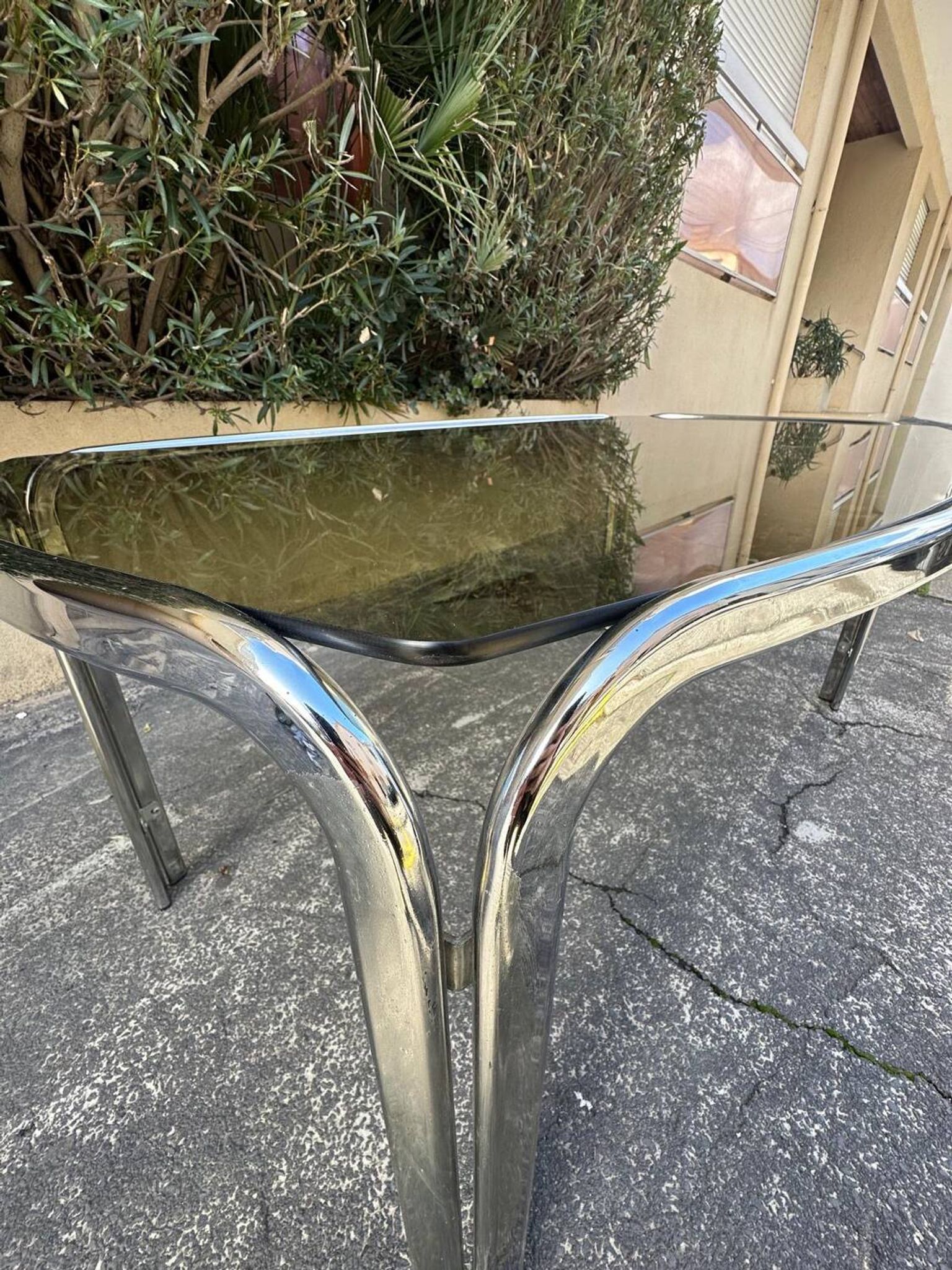 Vintage curved rectangular dining table in smoked glass and metal.