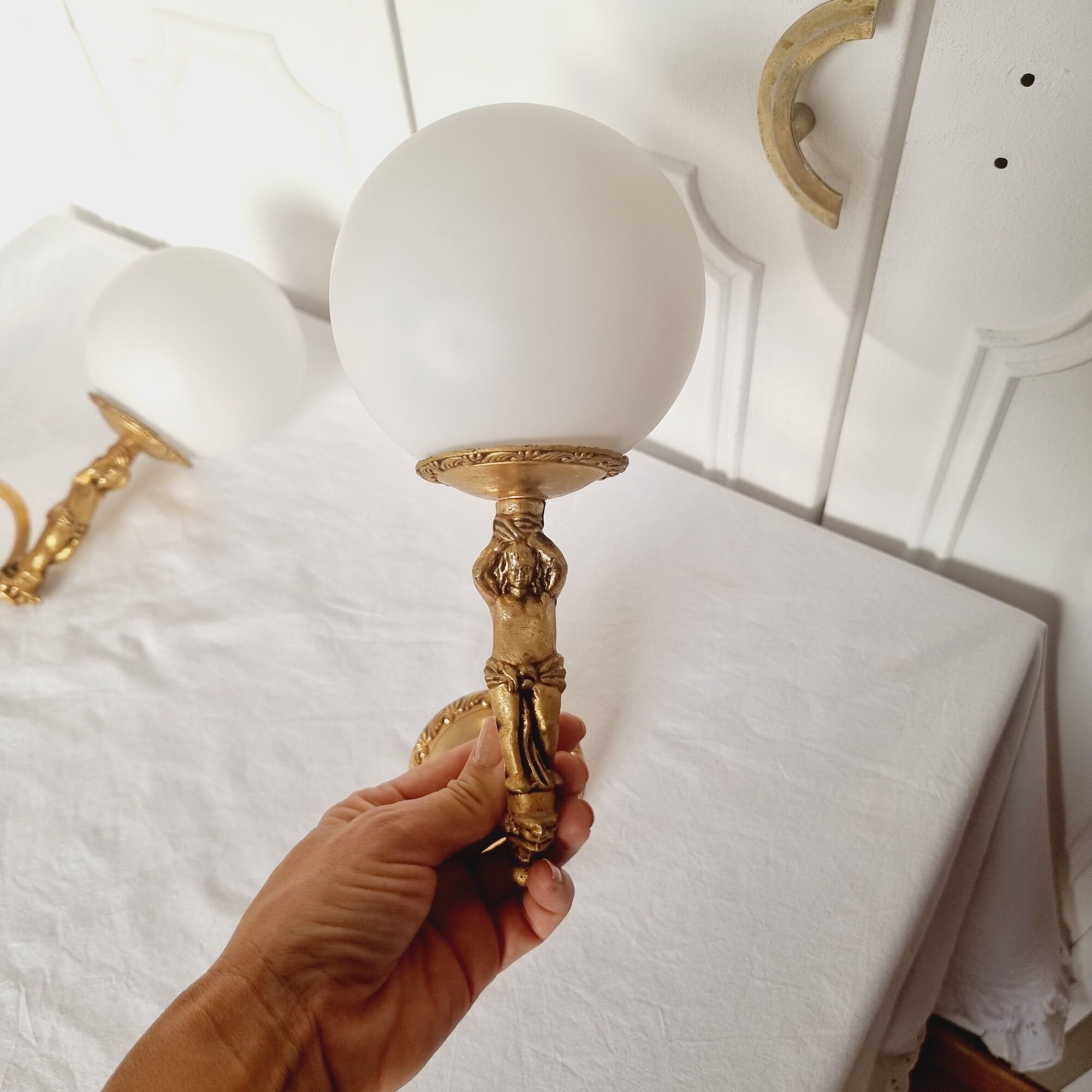 2 classic golden cherub wall lights and globe lampshades in perfect condition.