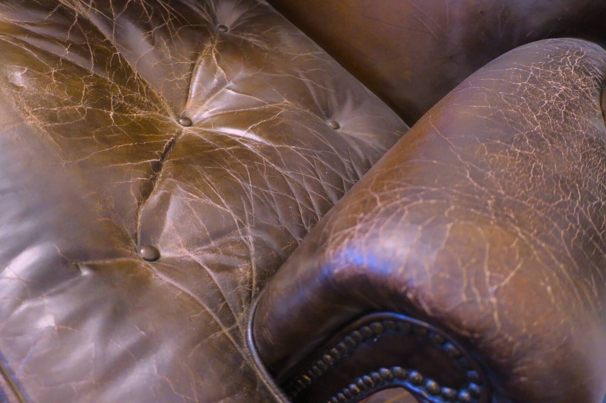 Wingback armchair in dark brown patinated leather, 1970s