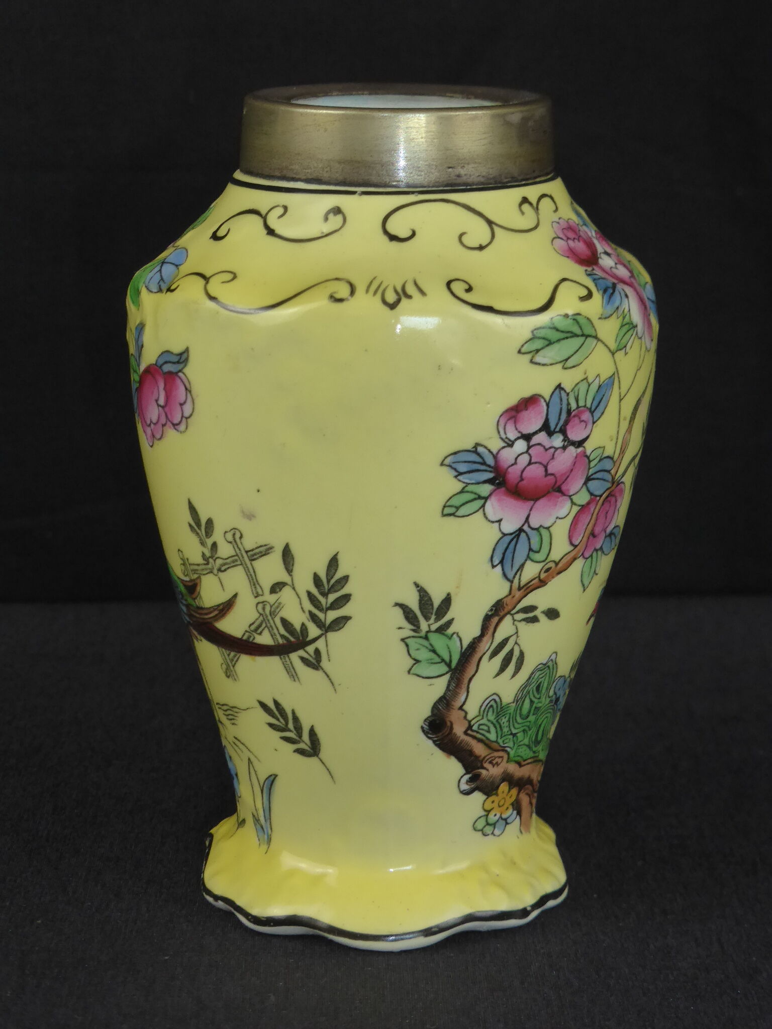 Old yellow ceramic vase decorated with flowers and a pheasant