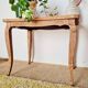 Antique coffee table with curved legs.