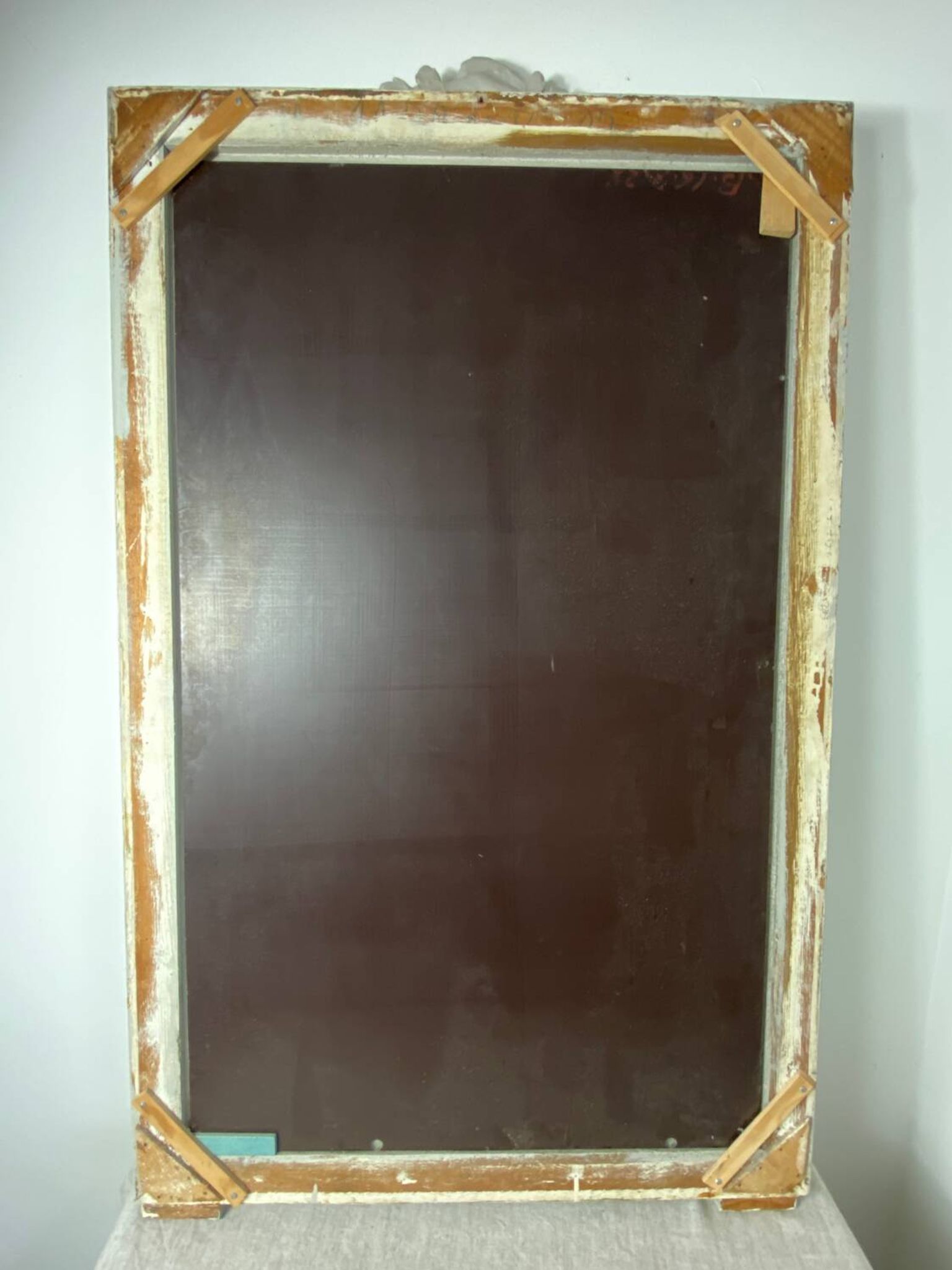 Large antique beveled mirror in carved wood painted with floral decoration and
