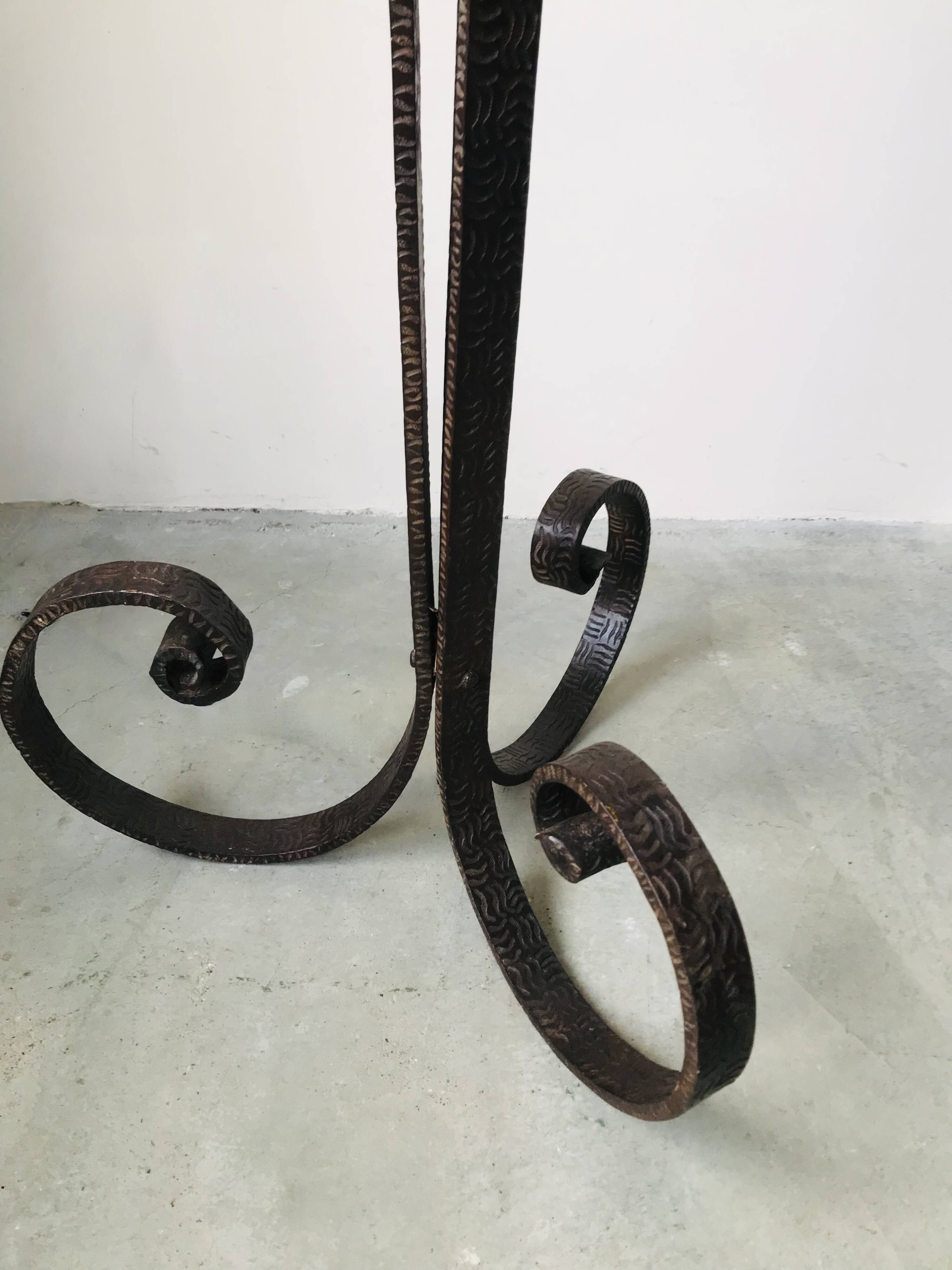 Art deco wrought iron floor lamp decorated with flowers, circa 1930.