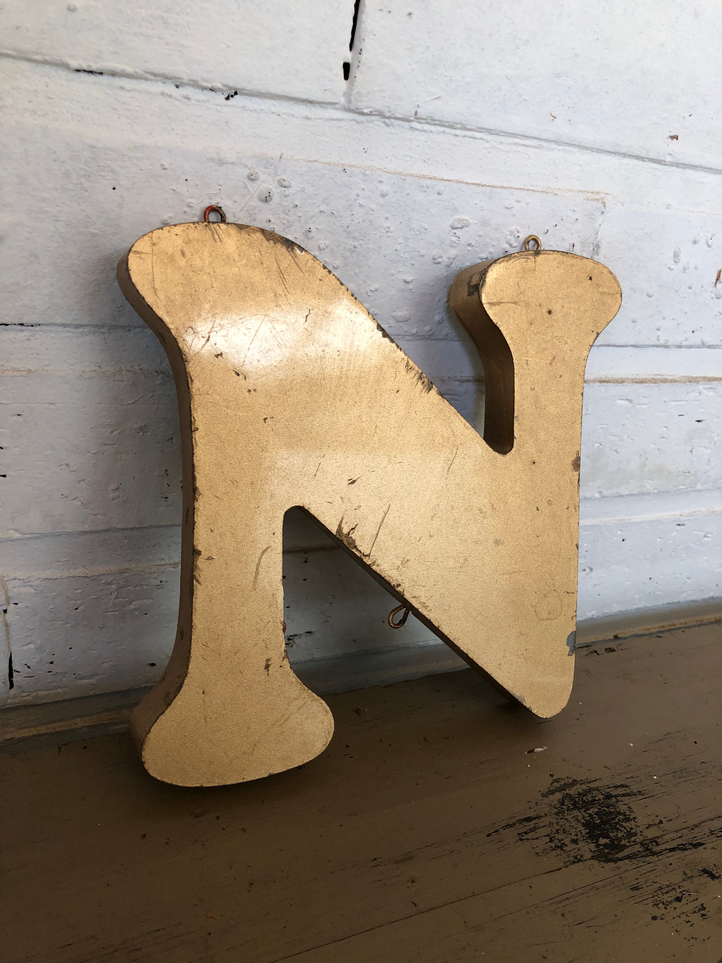 Golden sign letter "N"
