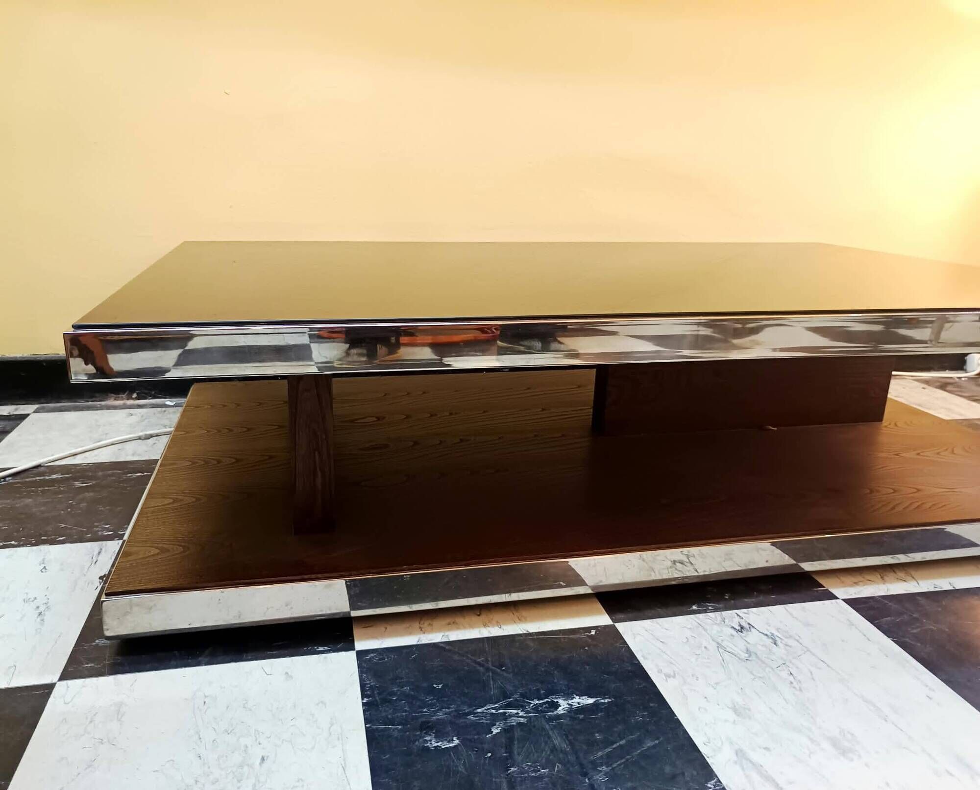 Designer coffee table in glass and chrome metal.