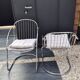 A pair of space age wire chairs