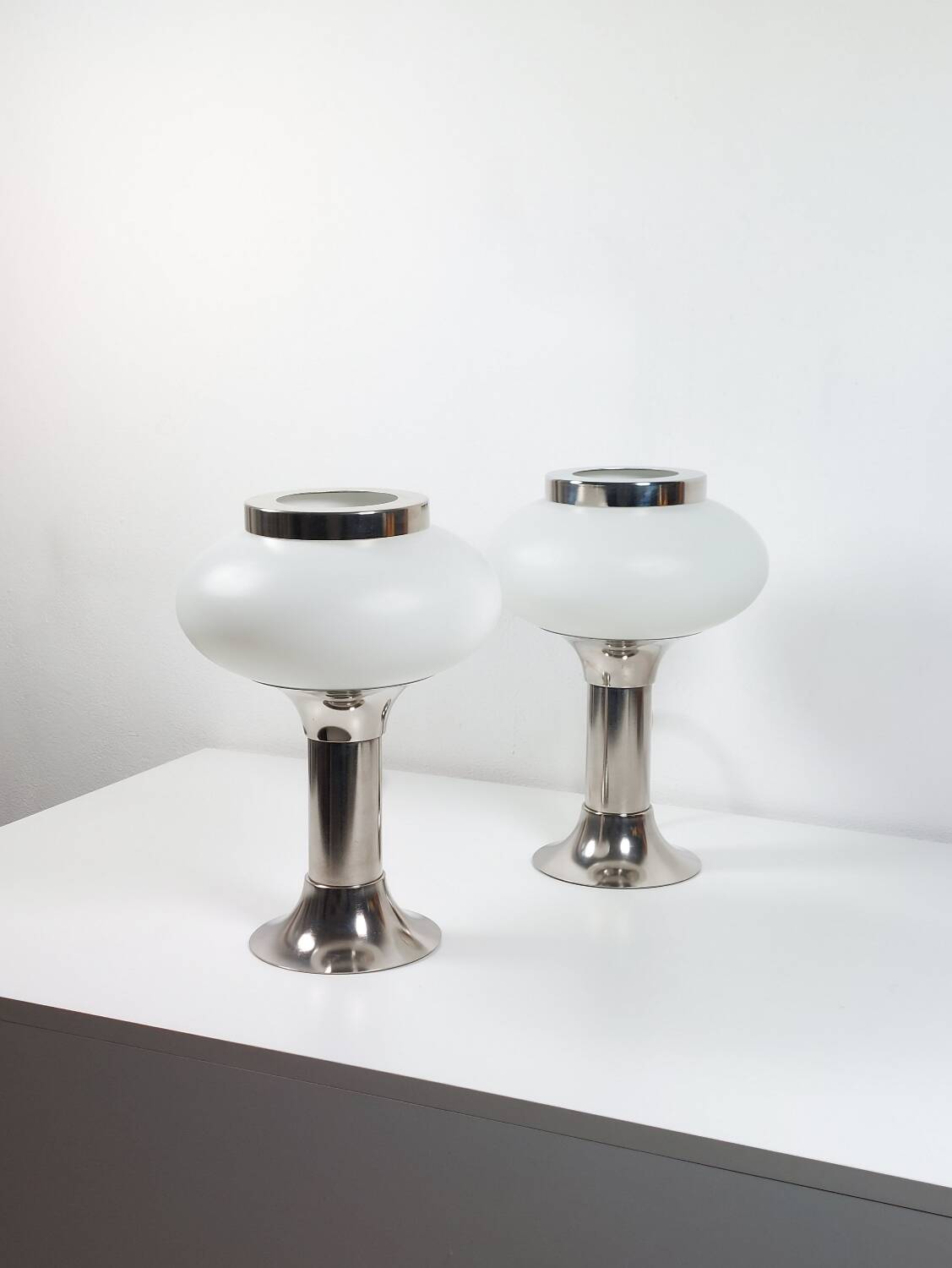 Pair of vintage futuristic style table lamps in chrome and opal glass.