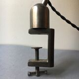 Old industrial lamp has vise 'mazda '.