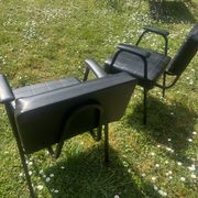 Pair of vintage industrial armchairs in black imitation leather and metal legs