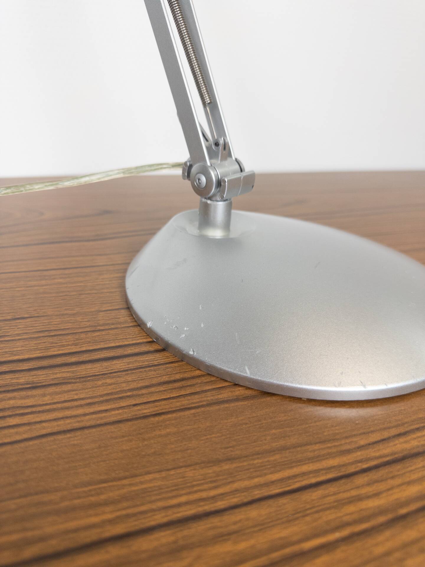 Grey LED architect lamp with spring arm and swivel base.
