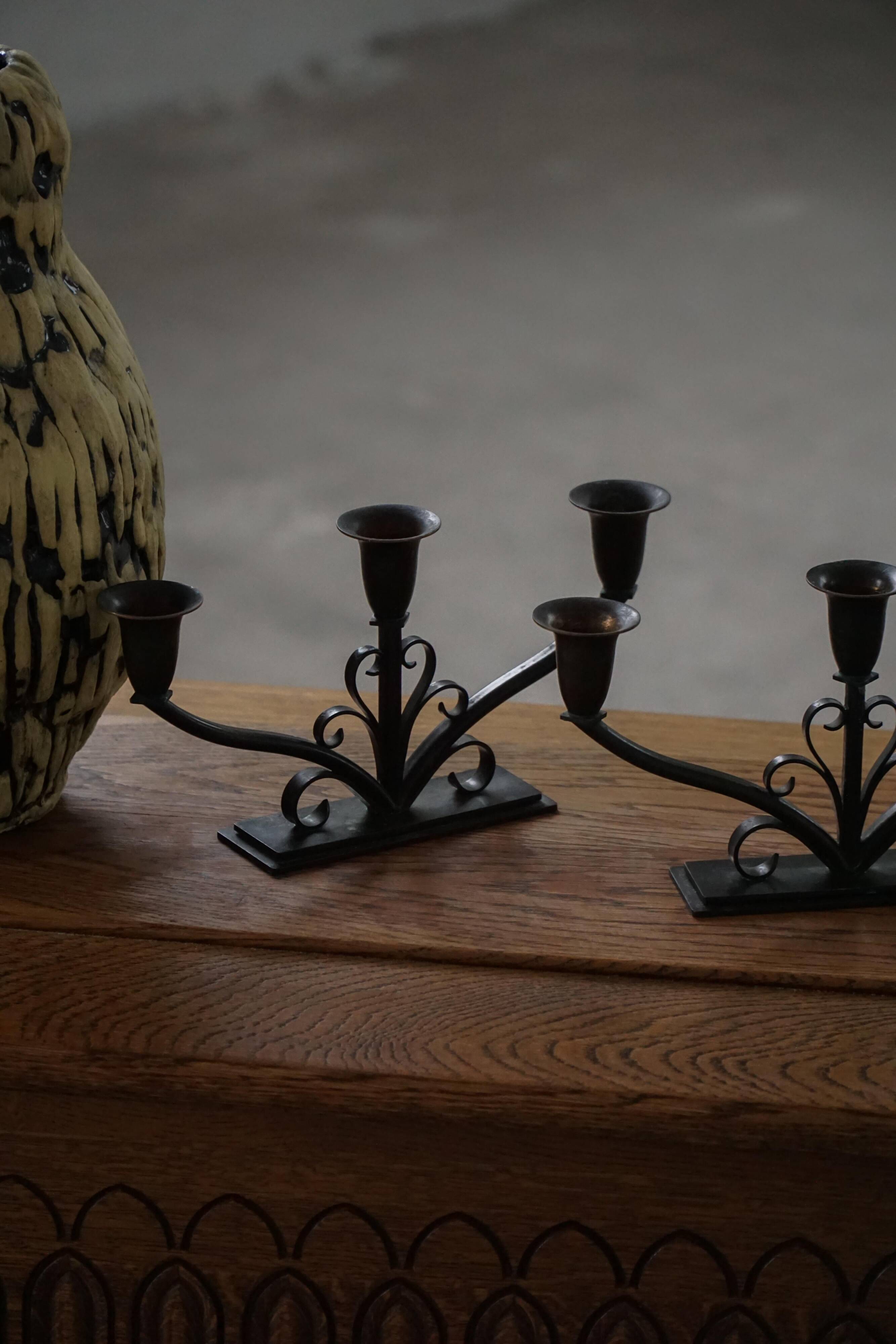 Early 20th century, pair of Danish Art Deco candlesticks in metal with three arms, 1930s.