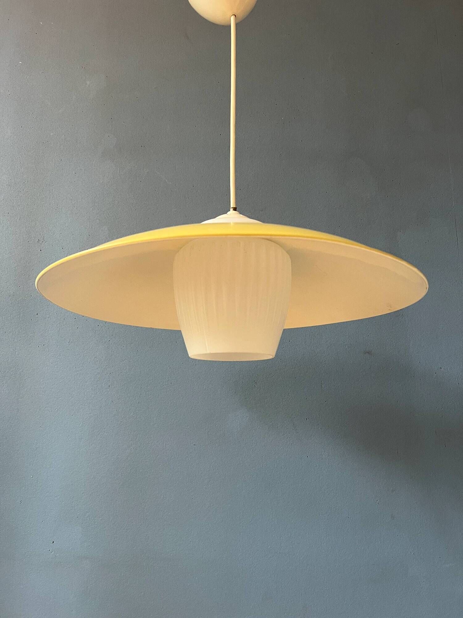 Danish mid-century suspension with opaline glass shade and yellow metal cover.
