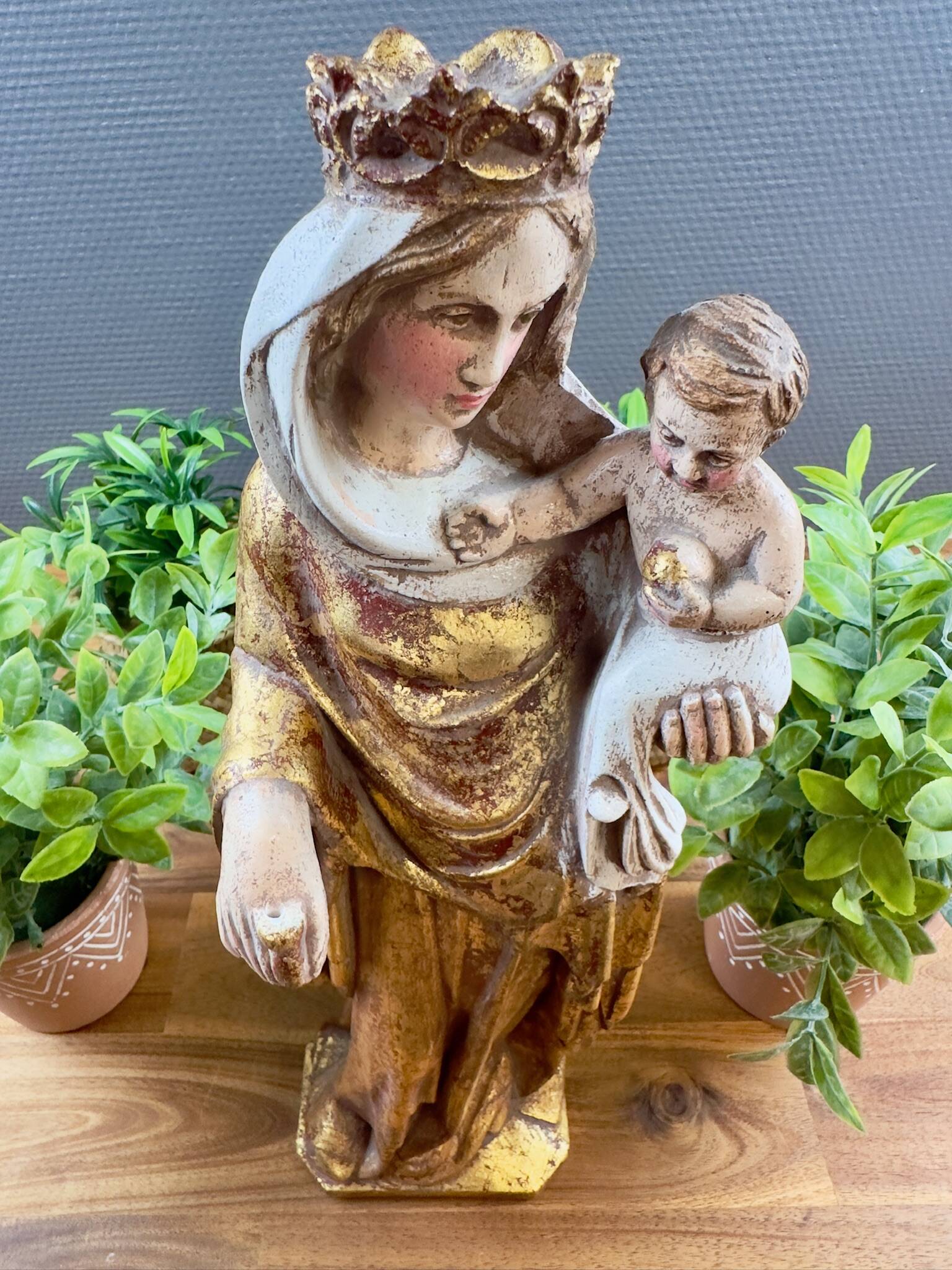 Statue of the Virgin holding the Child Jesus in polychrome terracotta.