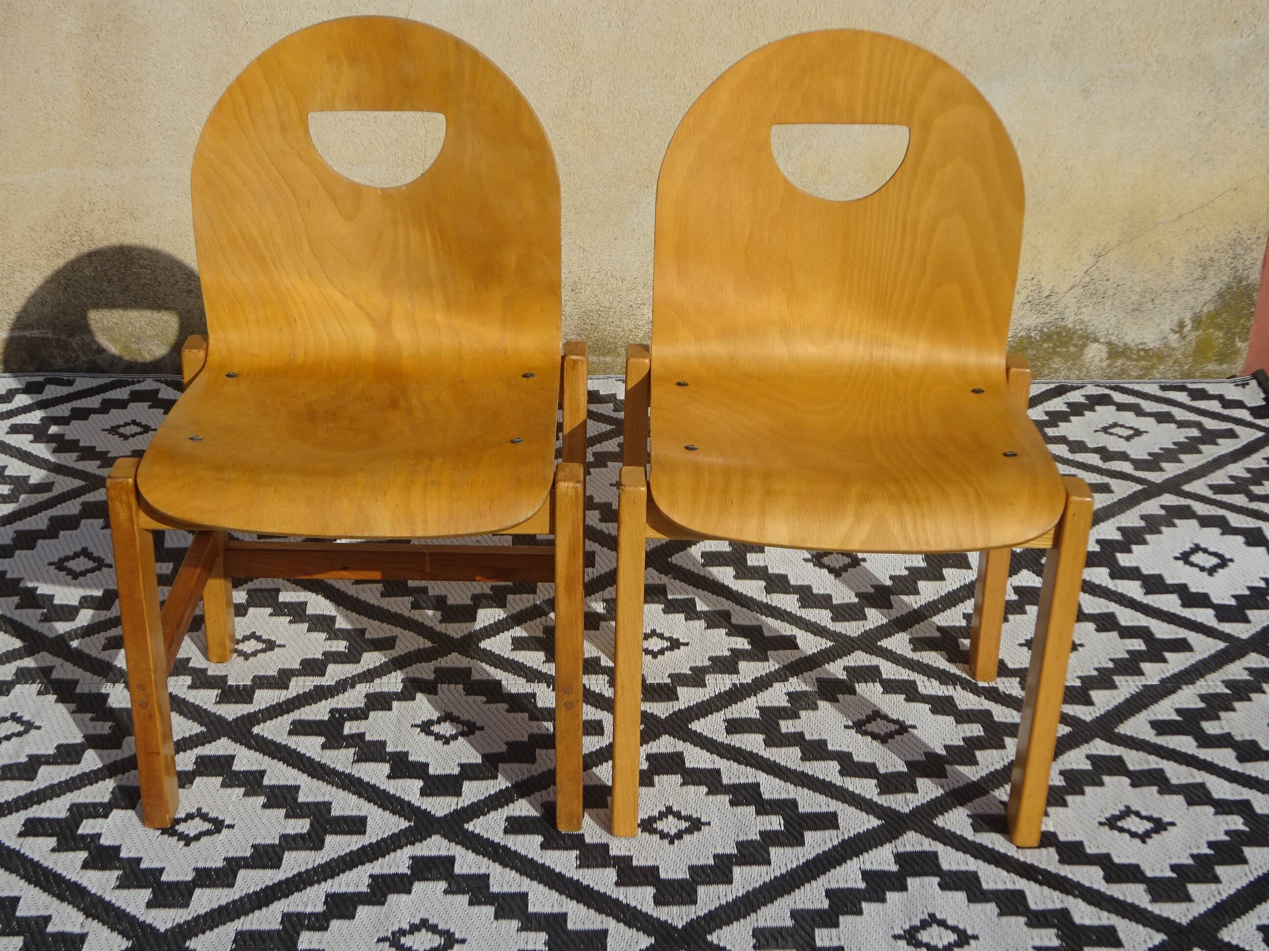 Pair of light wood chairs with post-formed seat and backrest.