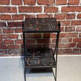 Black metal server and earthenware tiles with geometric patterns