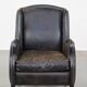 Black cow leather armchair in industrial style finished with decorative nails