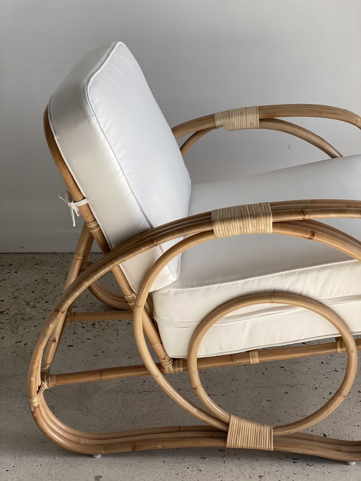 Large rattan rest chair and white cushions