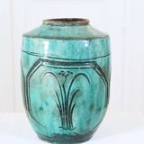 Chinese glazed earthenware vase with bird and flower decoration on a green background