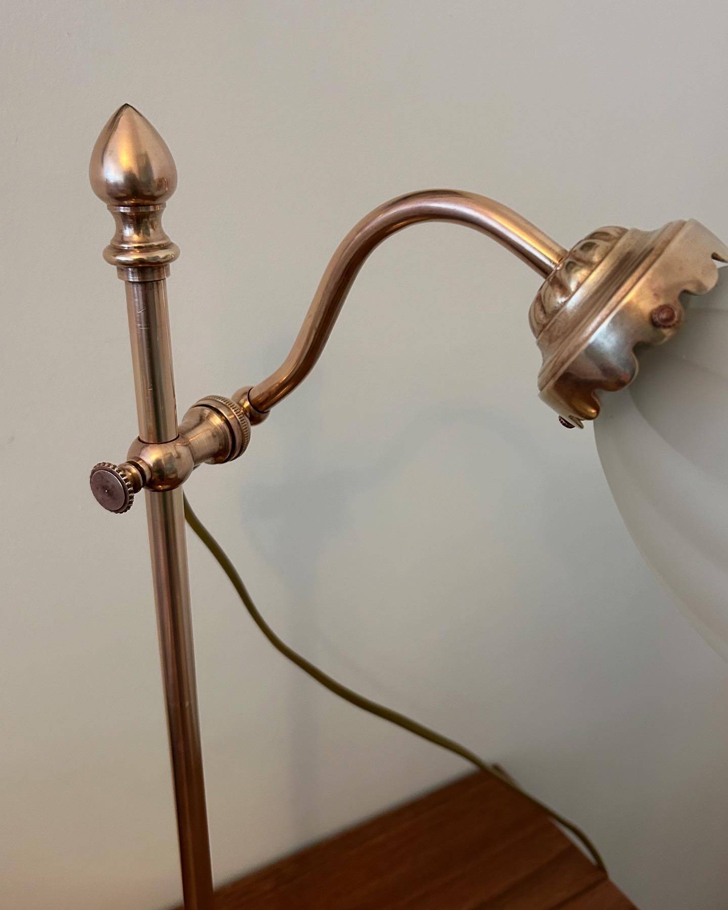 Articulated brass lamp with glass shade, early 20th century.