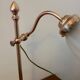 Articulated brass lamp with glass shade, early 20th century.