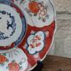 Antique Imari deep plate with red and blue floral decoration, 21.5cm.