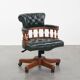 Dark green leather Chesterfield office chair on wheels.