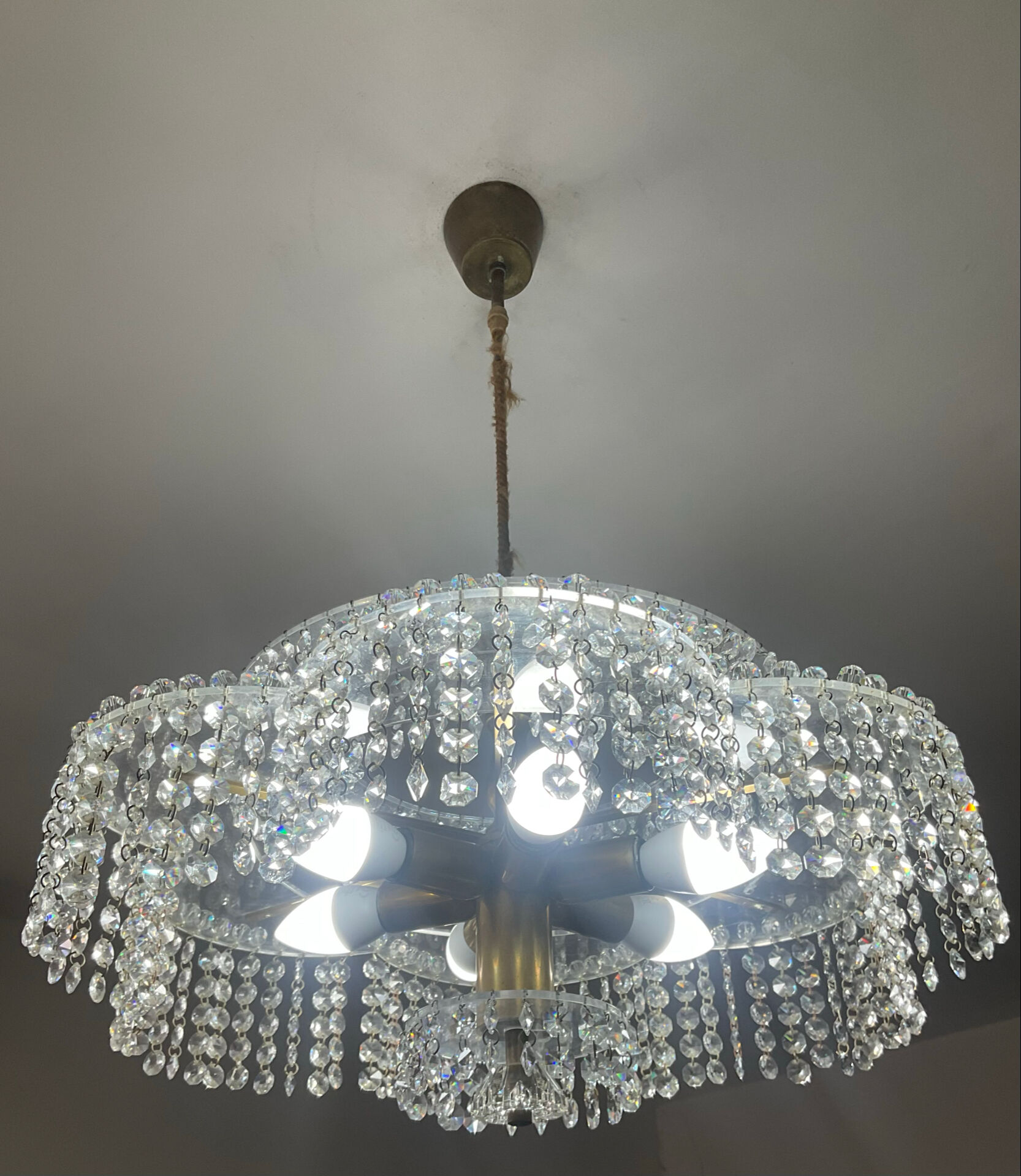 Vintage lucite chandelier with a cascade of crystal pendants from the 1970s.