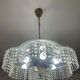Vintage lucite chandelier with a cascade of crystal pendants from the 1970s.
