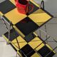 Vintage black and yellow checkered rolling bar trolley