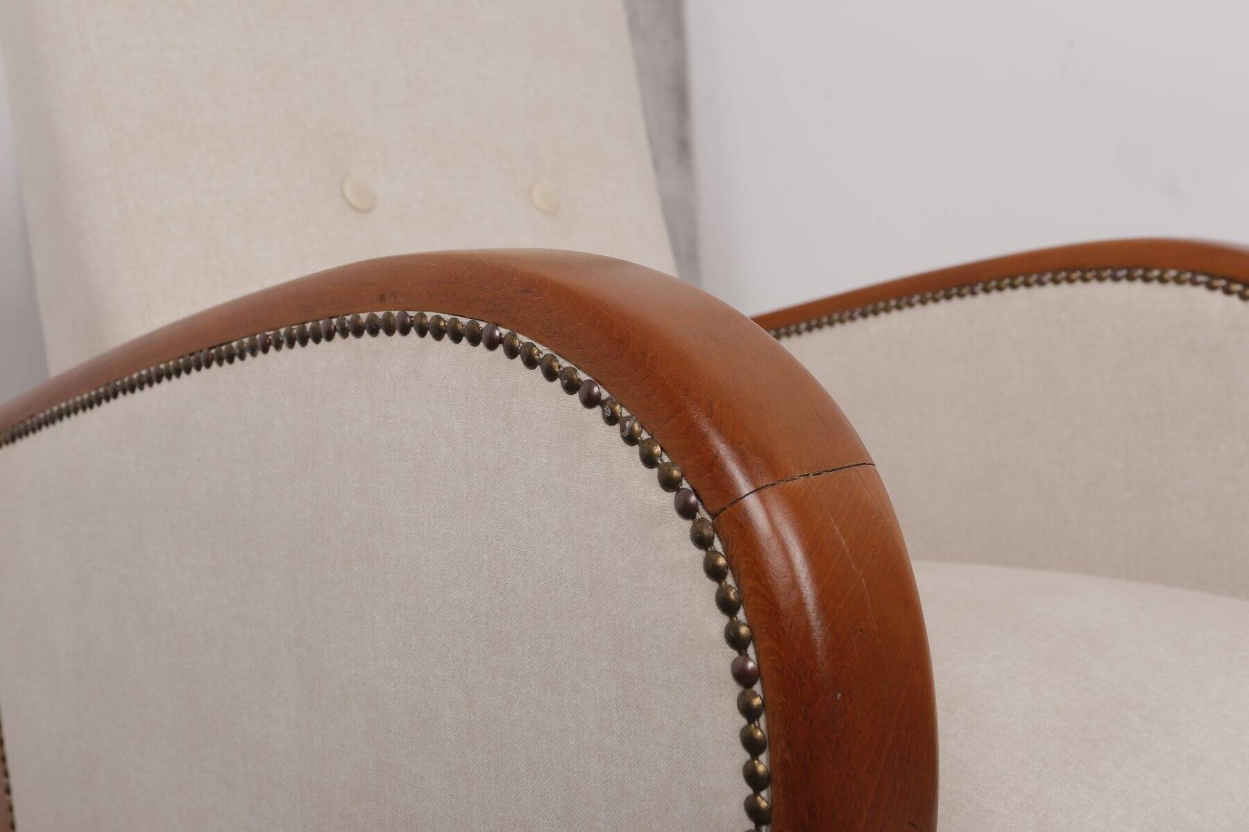Art Deco armchair from the 1930s in beige fabric and carved wood, Hungarian origin.