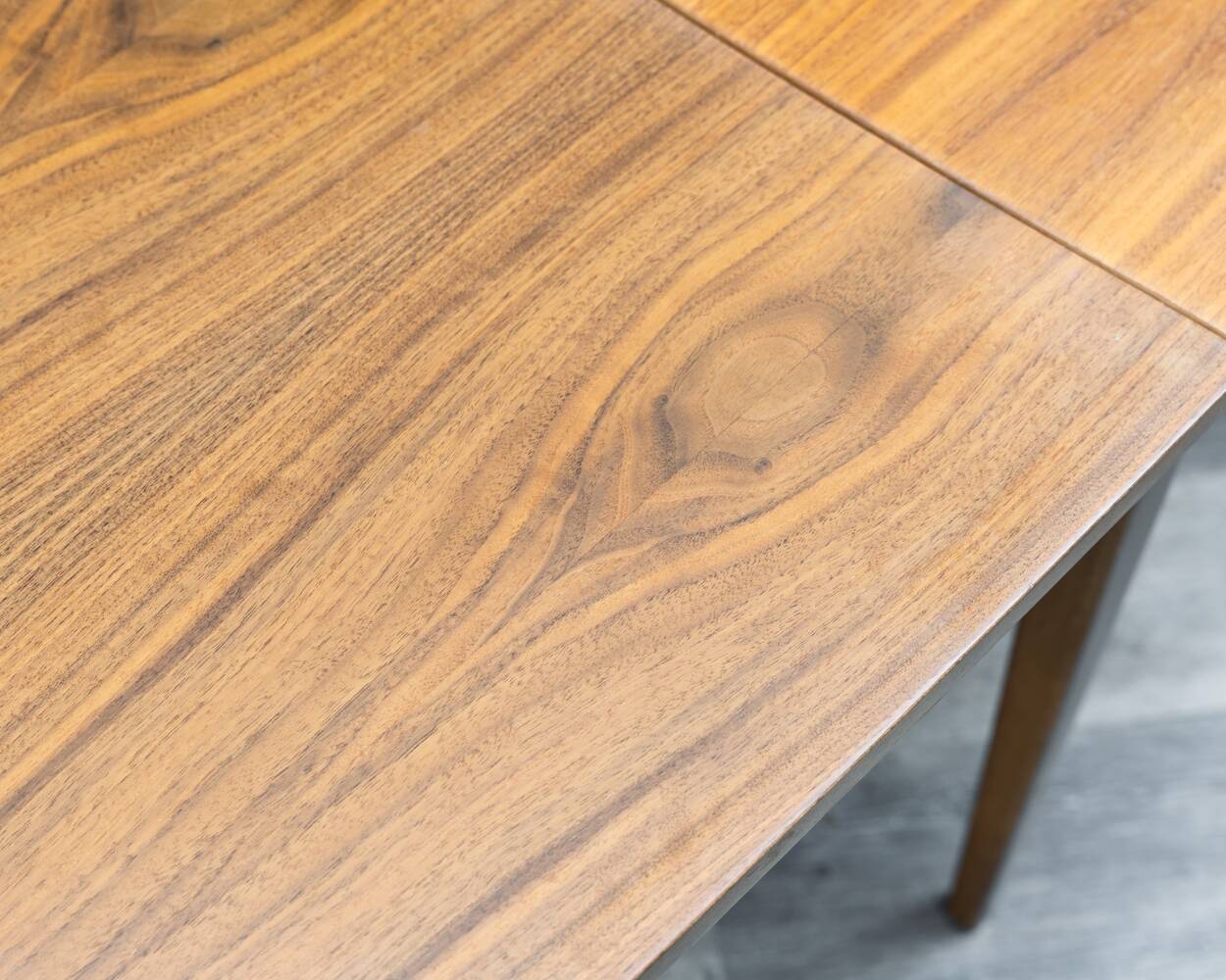 Dining table, 1960s, in walnut, slightly elliptical shape.