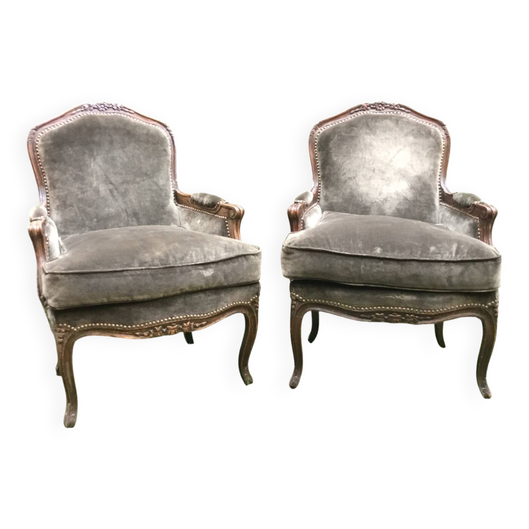 Pair of Louis XV style bergères in moulded and carved wood.
