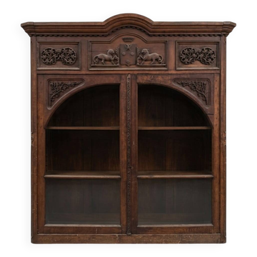 Antique library furniture from a castle decorated with a lion crest.