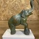 Pair of art deco bookends with elephant decoration in regulated and travertine, vintage