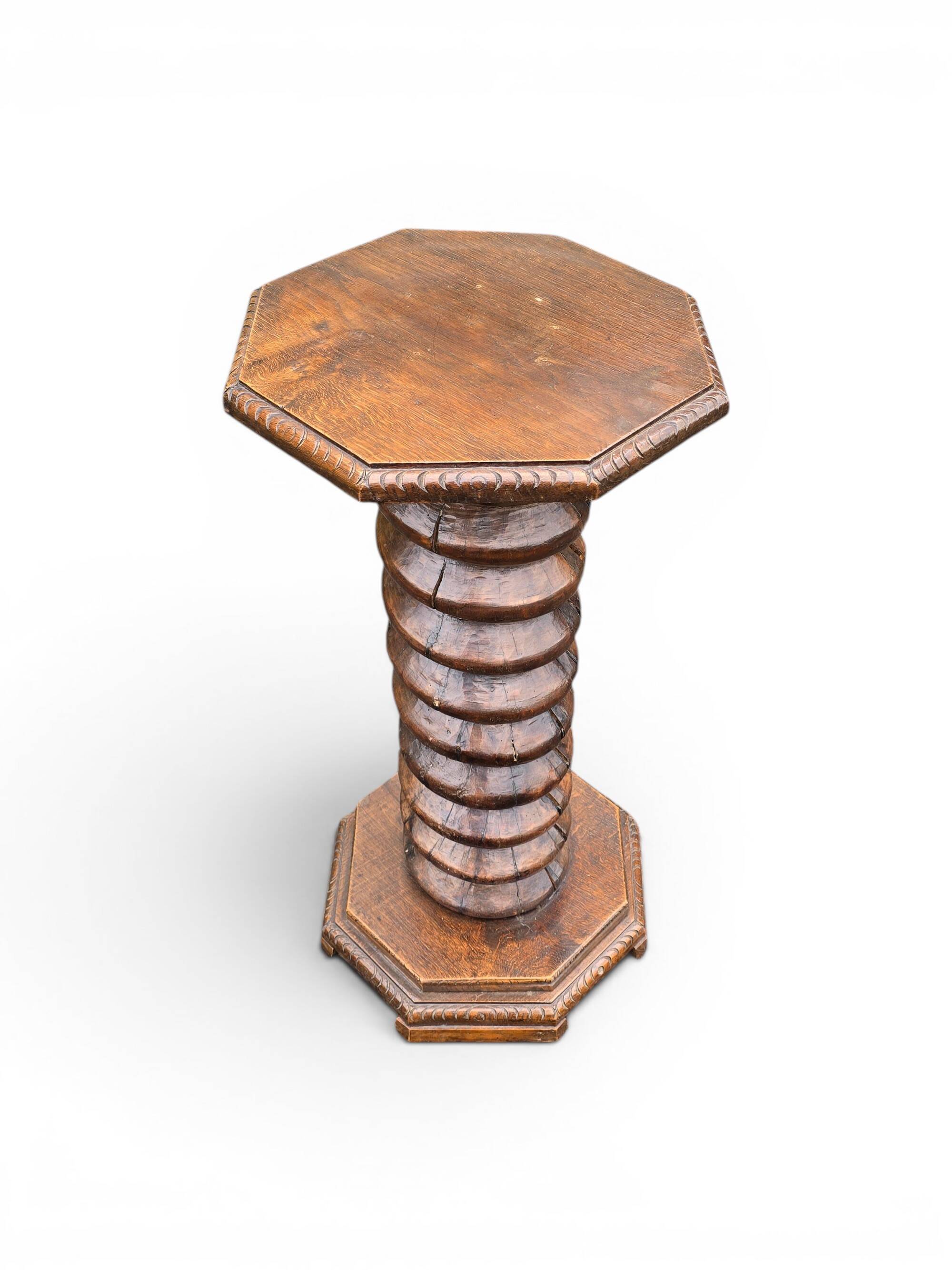 Antique carved solid oak pedestal, octagonal top and turned column.