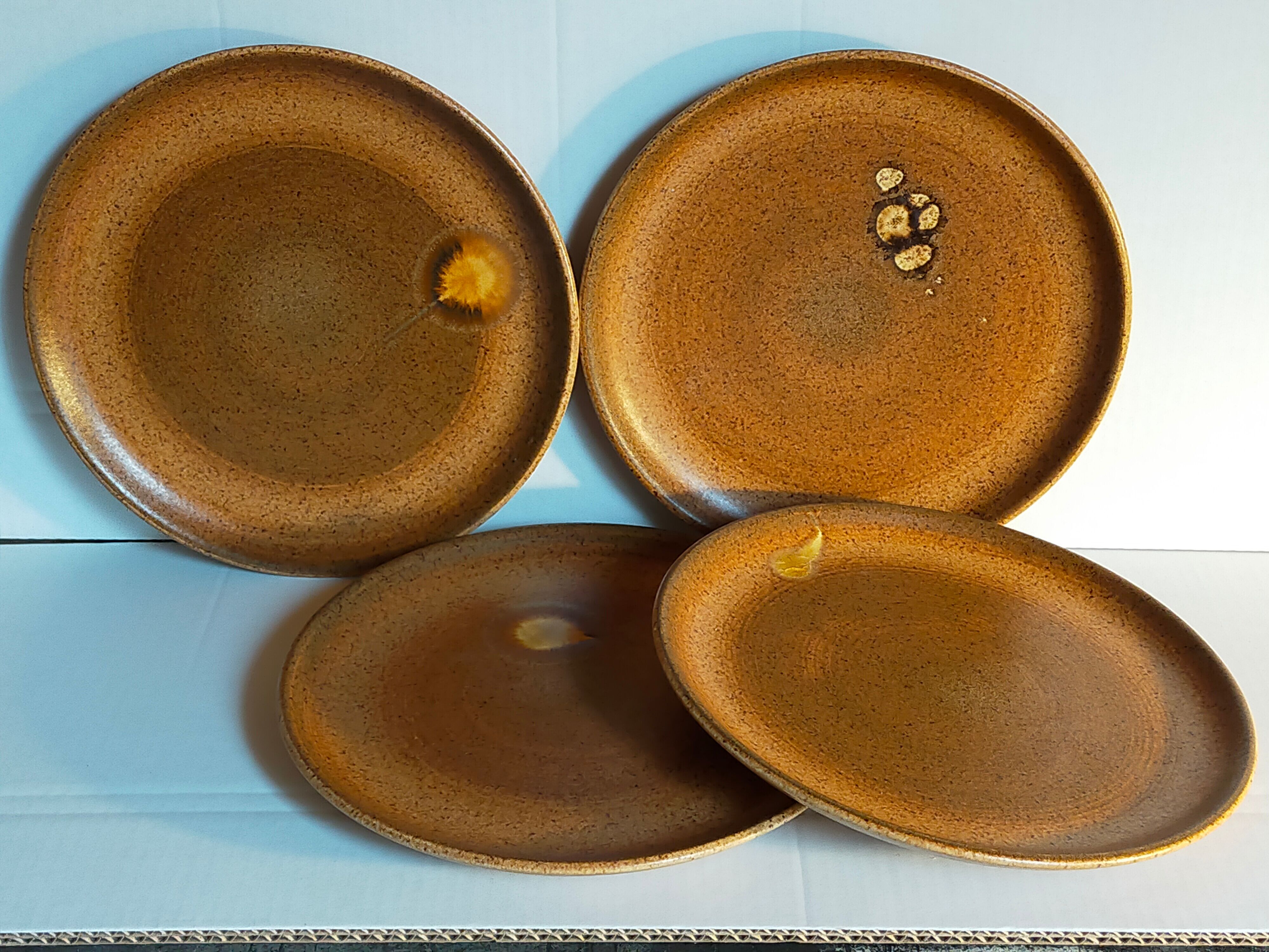 Four vintage glazed stoneware potter's plates