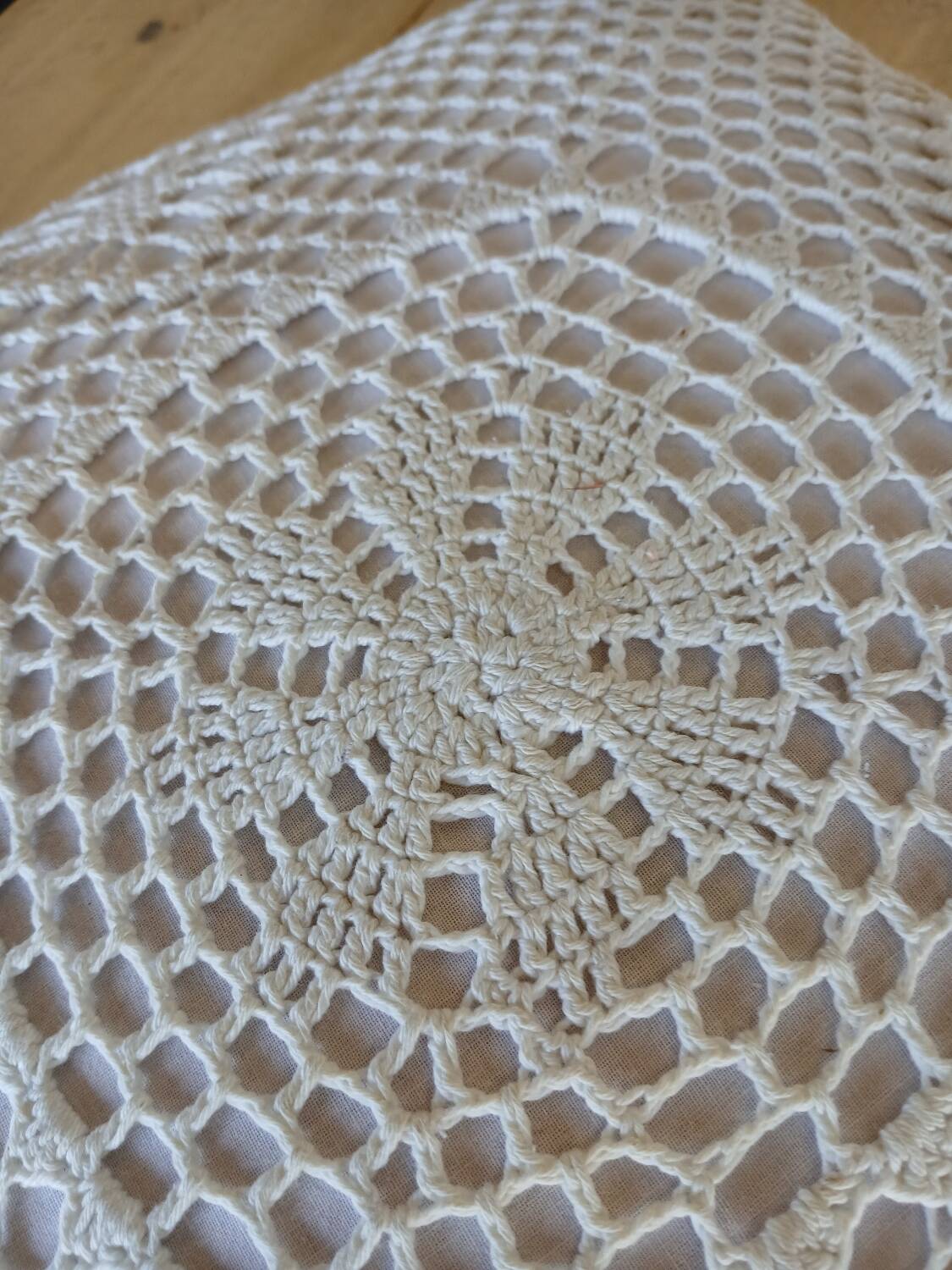 Cushion with white crochet cover