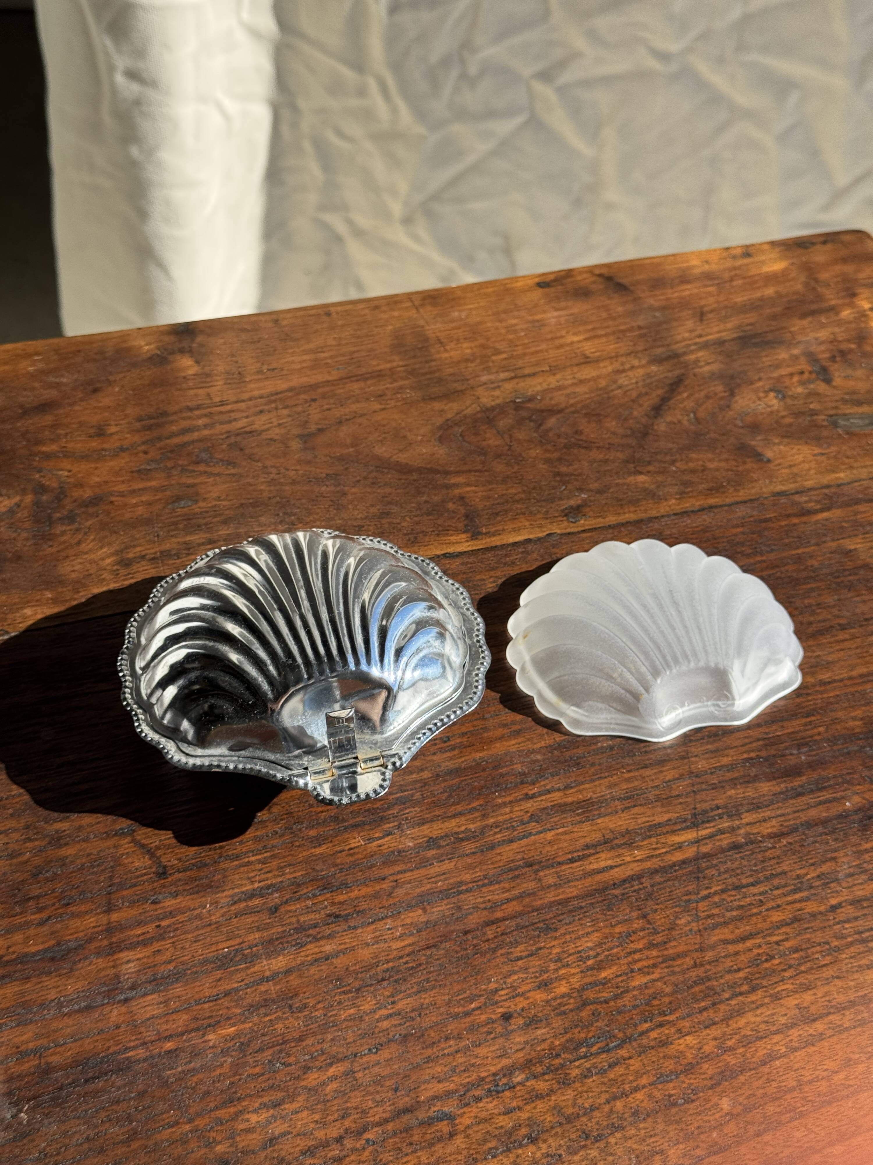 Vintage silver-plated shell butter dish with transparent bowl.