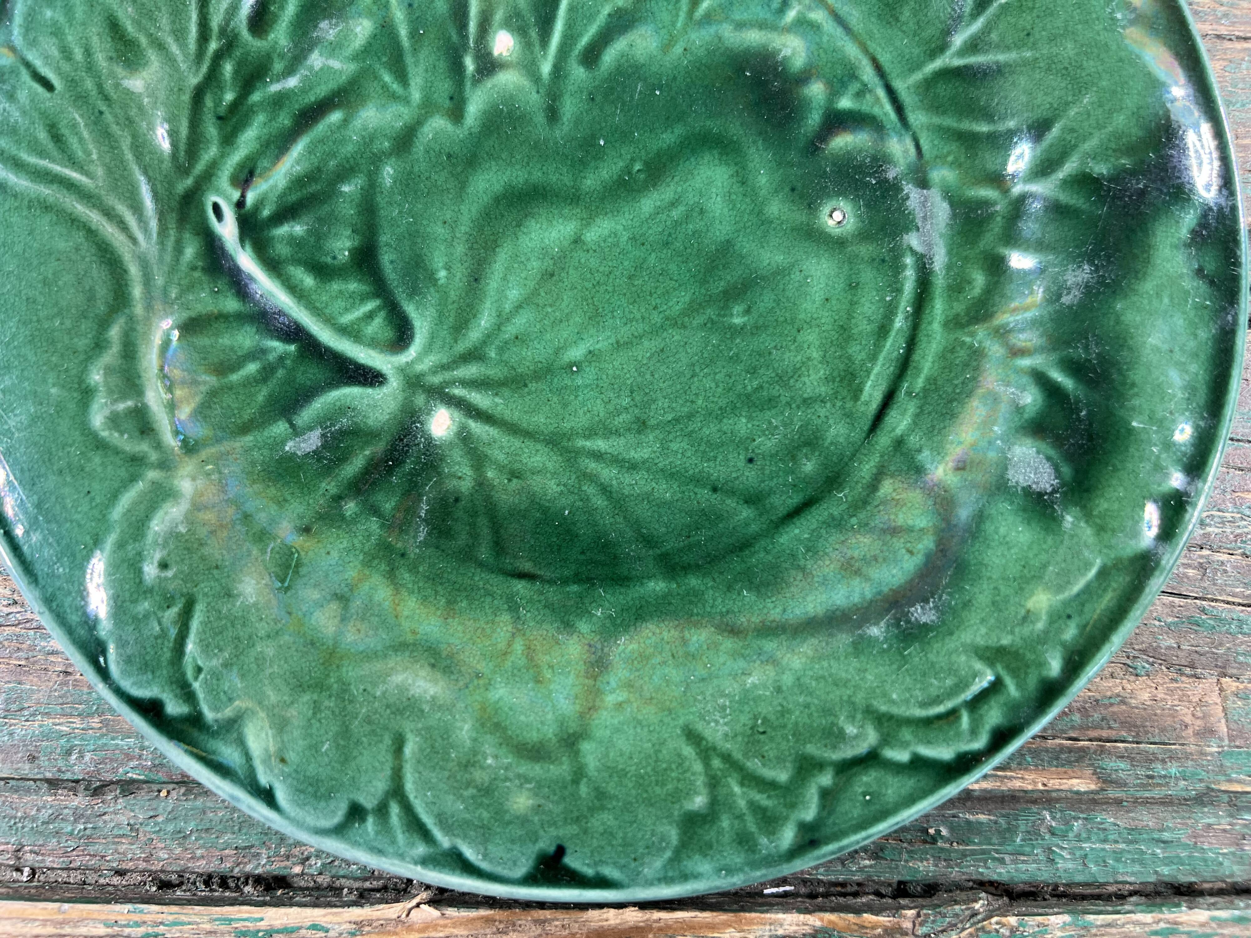 Pair of green slip plates with leaf decoration, 19th century