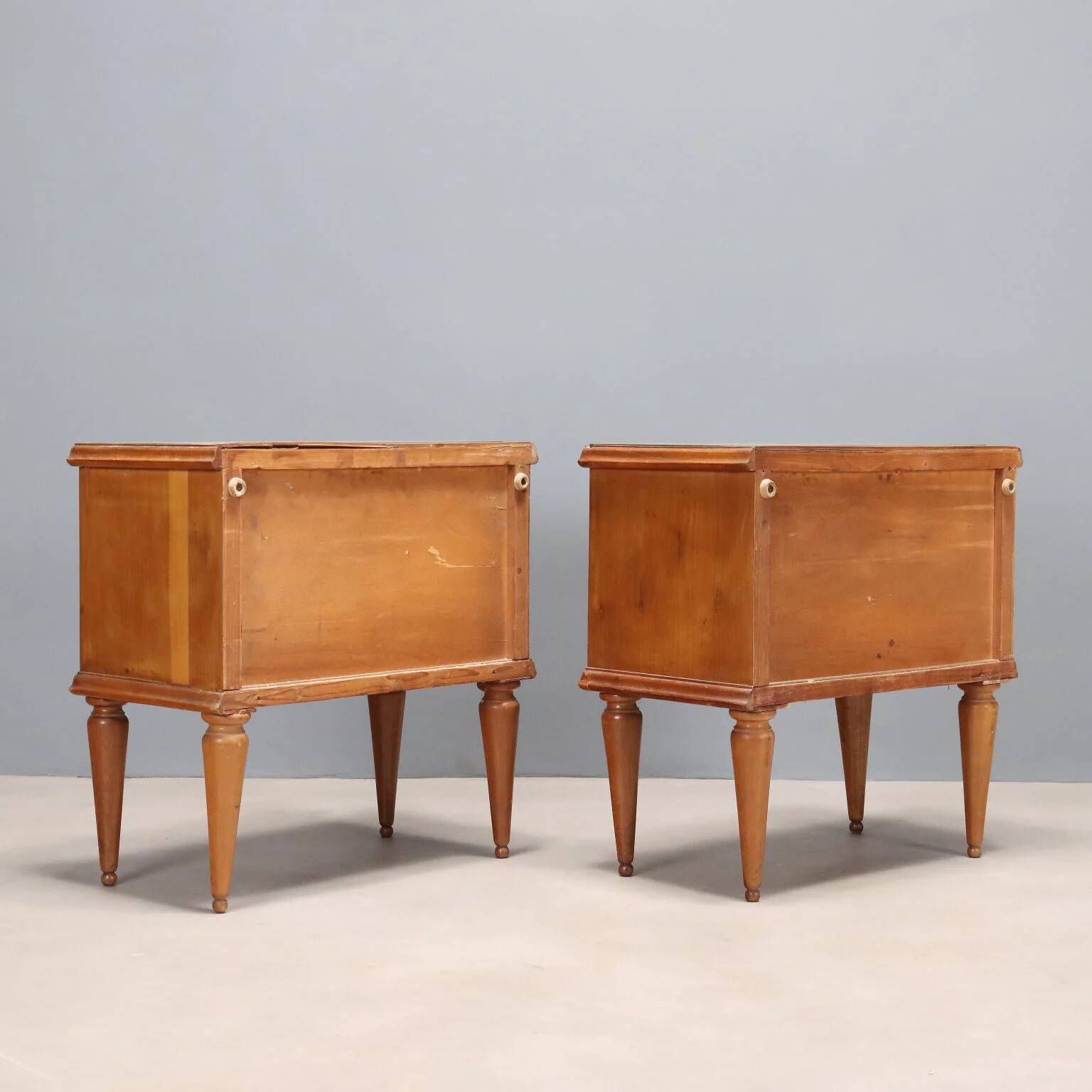 Pair of wooden and glass bedside tables from the 1950s.