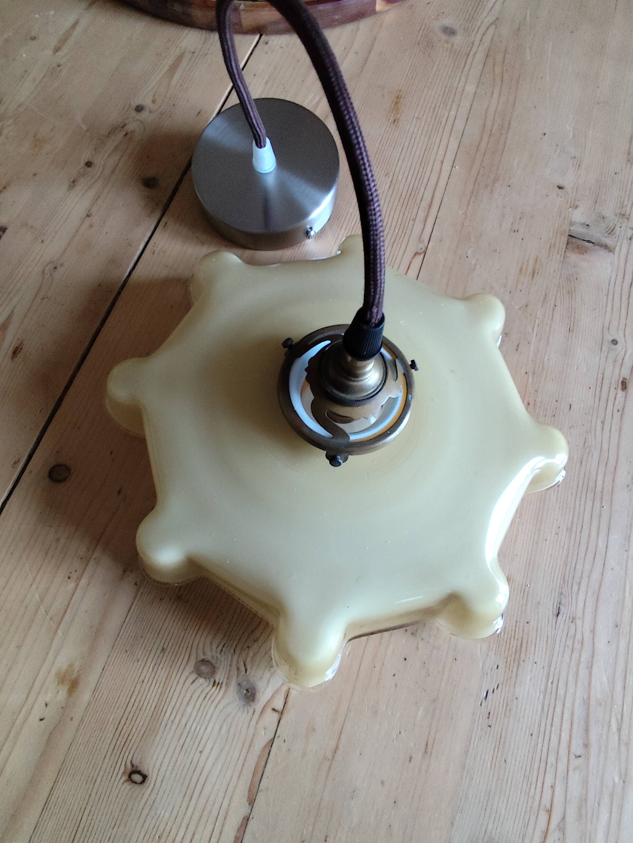 Electrified suspension with a frosted opaque glass disc shade.