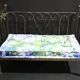Wrought iron bed and bluish wool mattress