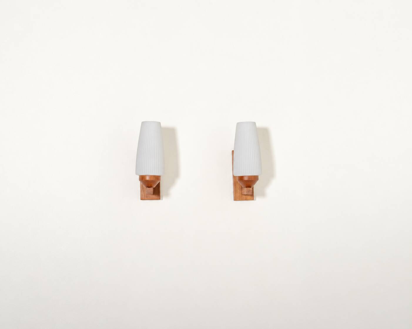 Pair of teak and opaline glass wall lamps, 1950s/1960s