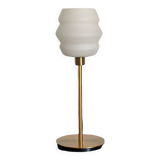 Table lamp with a vintage white glass globe and a golden base
