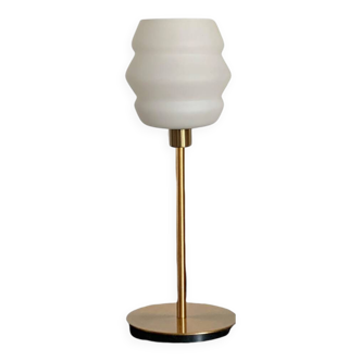 Table lamp with a vintage white glass globe and a golden base