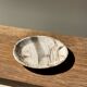 Tray, circular dish or plate made of white striped grey petrified wood.